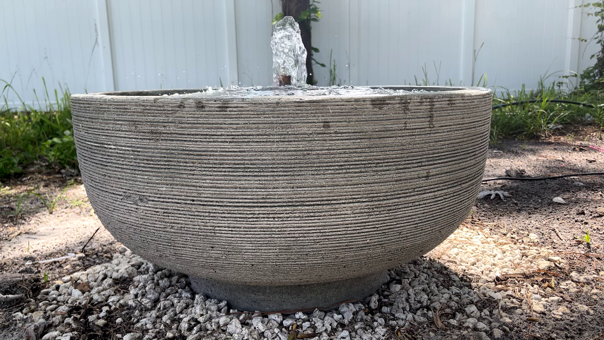 Front view of the Girona Fountain featuring a textured cast stone bowl with a gentle bubbling water feature