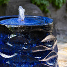 Close-up of Riviera Blue Rumba Fountain showing glazed texture and bubbling water feature