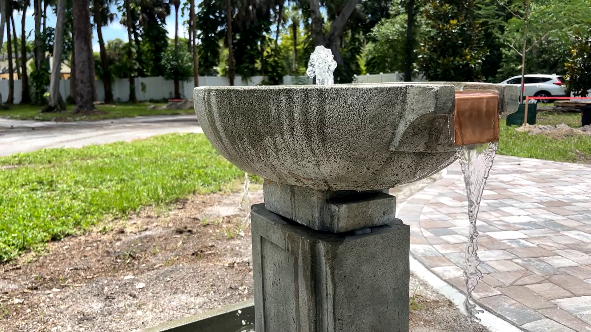 Side view of the Austin Fountain featuring a cast stone bowl, bubbling center, and copper spillway with cascading water