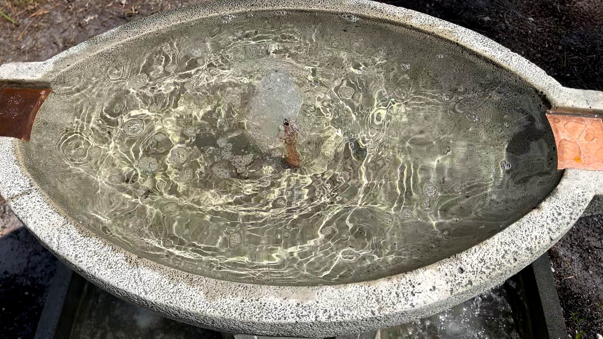 Top view of the Austin Fountain showcasing the bubbling center and circular cast stone basin with four copper spillways