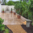 Estancia and Andra Fountains with Garland Rim Italian terra cotta planters in a lush landscaped outdoor space