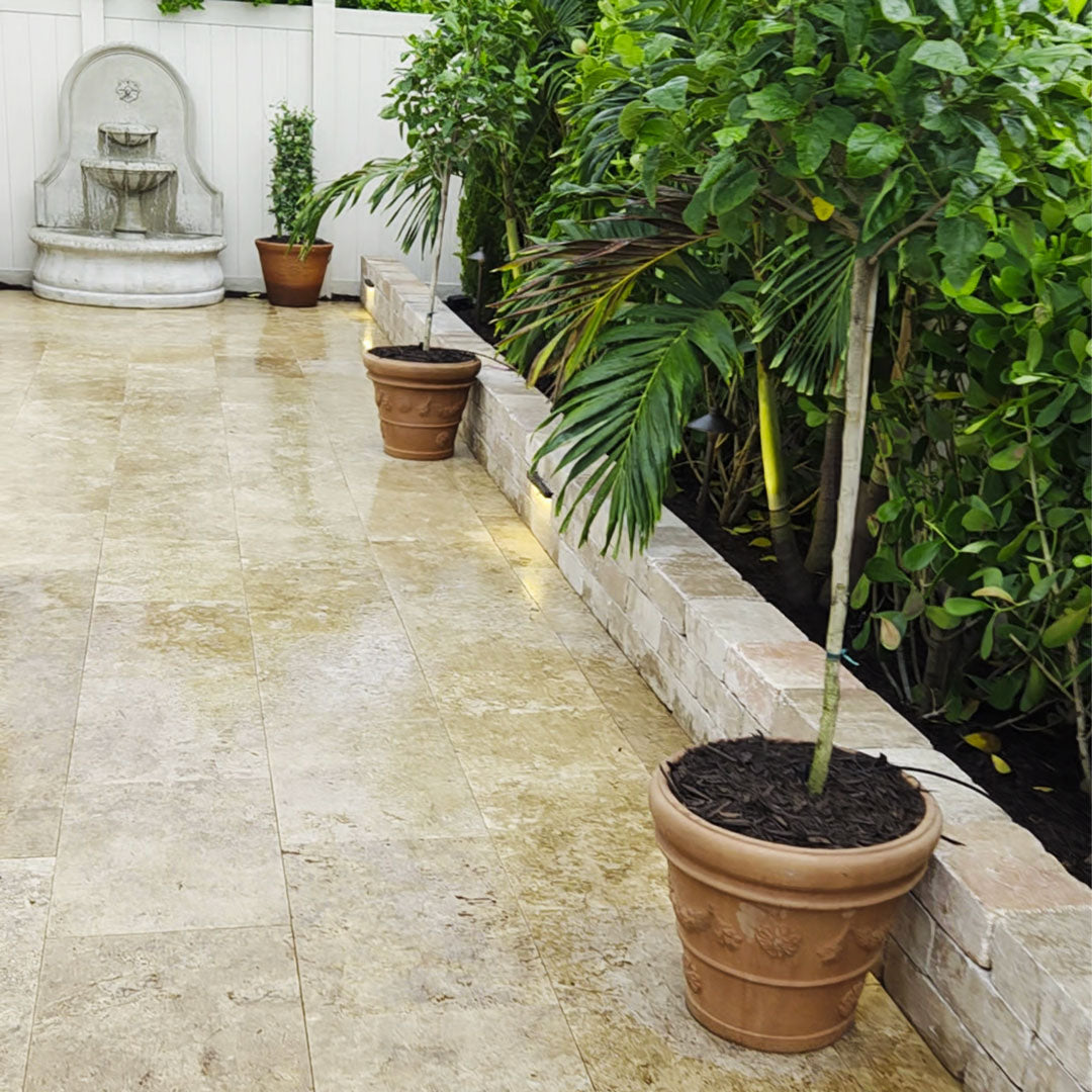 Garland Rim Italian terra cotta planters with trees lining a tropical garden walkway near the Estancia Fountain