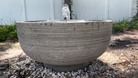 Front view of the Girona Fountain featuring a textured cast stone bowl with a gentle bubbling water feature