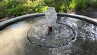 Close-up of the Girona Fountain's bubbling center showcasing gentle water movement and textured cast stone details