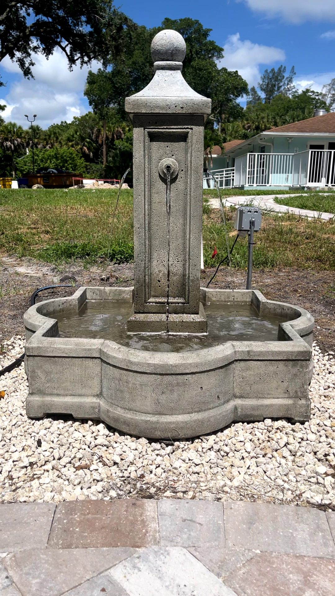 Front view of the Provence Fountain featuring a classic cast stone design with water flowing from all four sides