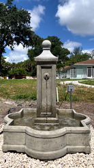Provence Fountain displayed in a landscaped outdoor setting with symmetrical cast stone architecture and flowing water