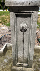 Close-up of the Provence Fountain highlighting one of the cast stone water spouts and smooth cascading water