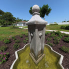 Close-up of the Provence Fountain showing water streams flowing from the cast stone column into the decorative basin