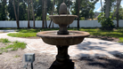 Rear view of the Wiltshire Fountain showcasing the two-tier cast stone design and surrounding patio