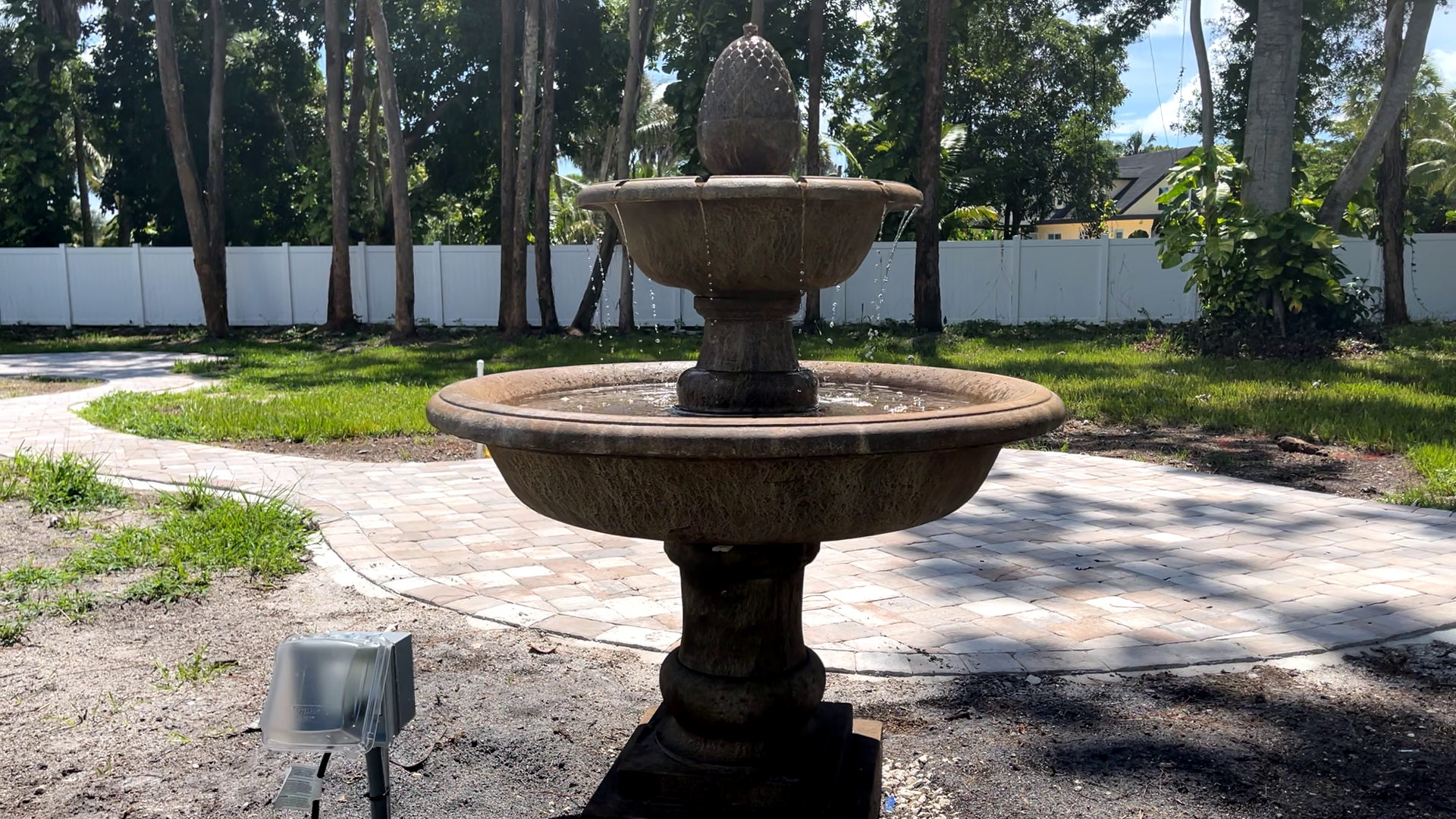 Rear view of the Wiltshire Fountain showcasing the two-tier cast stone design and surrounding patio