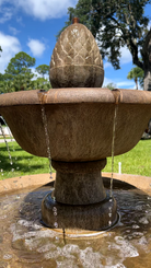 Close-up of the Wiltshire Fountain's upper basin and decorative finial with cascading water streams