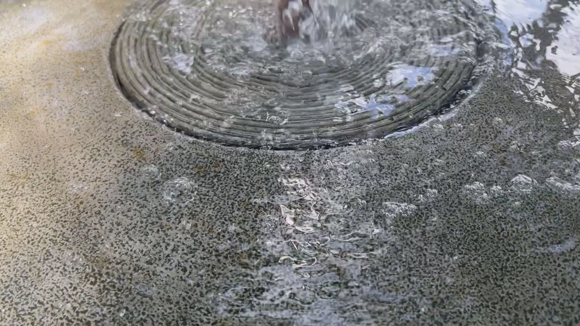 Girona Fountain with gentle bubbling water in a landscaped outdoor setting