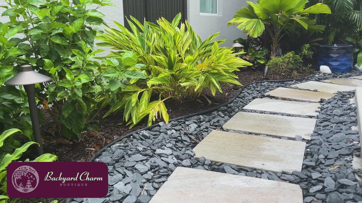 Rumba Fountain in Riviera Blue with bubbling water installed in a tropical residential landscape