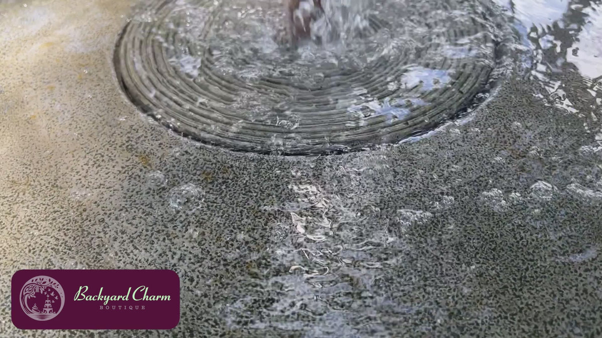 Girona Fountain with gentle bubbling water in a landscaped outdoor setting